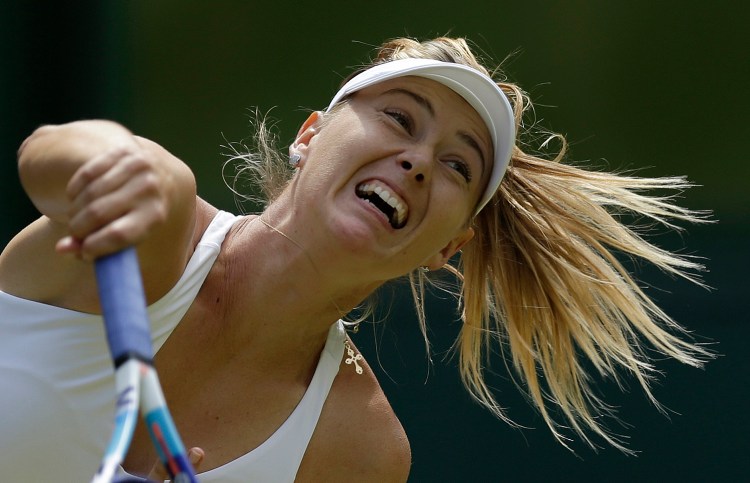 Maria Sharapova of Russia returns a ball to Coco Vandeweghe of the United States  during their singles match at the All England Lawn Tennis Championships in Wimbledon, London, on Tuesday. The Associated Press