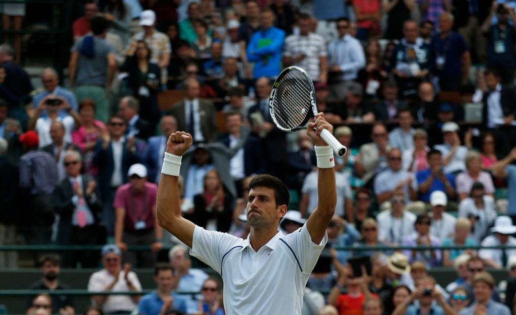 Novak Djokovic of Serbia celebrates winning the singles match against Kevin Anderson of South Africa, at the All England Lawn Tennis Championships in Wimbledon, London, Tuesday. The Associated Press