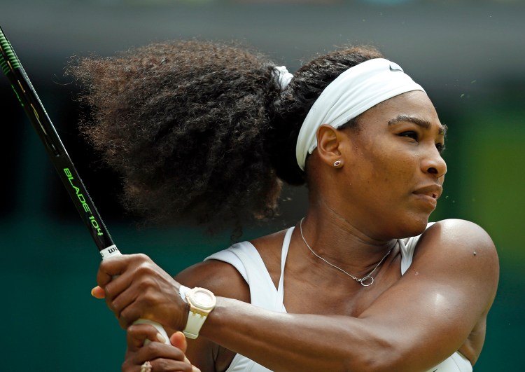 Serena Williams makes a return to Venus Williams  during their singles match at the All England Lawn Tennis Championships in Wimbledon, London, on Monday. The Associated Press