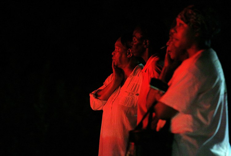 Bystanders watch as public safety personnel work at the scene of a fire at Mount Zion African Methodist Episcopal church in Greeleyville, S.C. The African-American church, which was burned down by the Ku Klux Klan in 1995, caught fire Tuesday night.