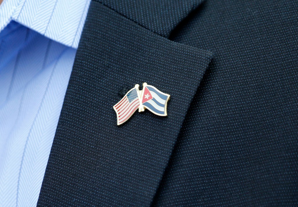 A member of the U.S. Senate delegation wears a crossed flag pin representing the American and Cuban national flags, at a press conference in Havana on Saturday. The bipartisan delegation was visiting Cuba as the two countries move toward reopening embassies and restoring long-strained diplomatic ties. The Associated Press