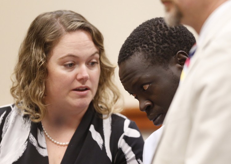 Gang Deng Majok confers with his attorney Kristine Hanley while being arraigned in the Cumberland County Courthouse in Portland on Wednesday in connection with the killing of Treyjon Arsenault.