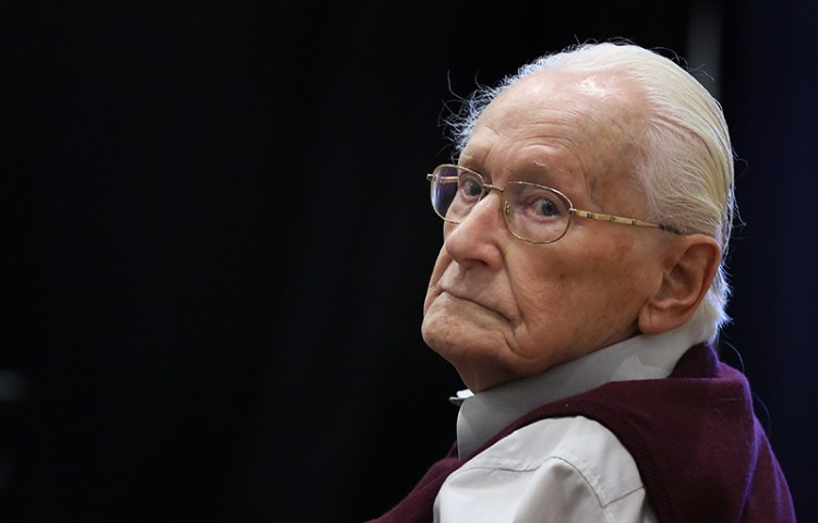 Former SS officer Oskar Groening, 94, sits in the courtroom in Lueneburg, Germany. Groening is charged with 300,000 counts of accessory to murder on allegations he helped the Auschwitz nazi death camp function by sorting cash and valuables seized from Jews.