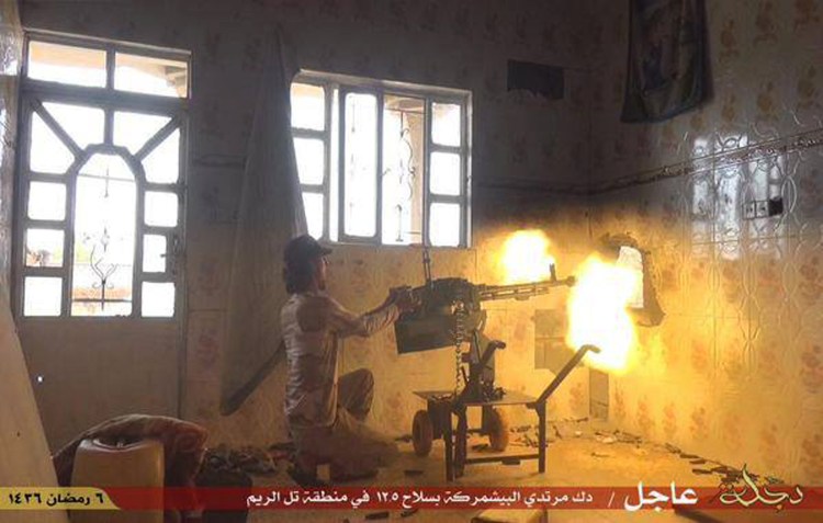 In this photo from an Islamic State  website, a militant fires an automatic weapon against Kurdish Peshmerga fighters in the village of Tel el-Reem, Iraq. Islamic State forces nimbly move between conventional and guerrilla warfare, using the latter to wear down their opponents before massed fighters backed by armored vehicles, Humvees and sometimes even artillery move to take over territory. (Militant website via AP)