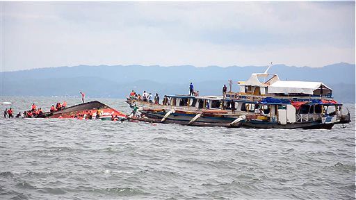 The Philippine Coast Guard rescues boat passengers after a ferry capsized in choppy waters Thursday in Ornoc, Philippines. The Ferry had just departed the port of Ornoc on Leyte heading to Camotes islands when it was capsized by large waves, the coast guard said. The Associated Press