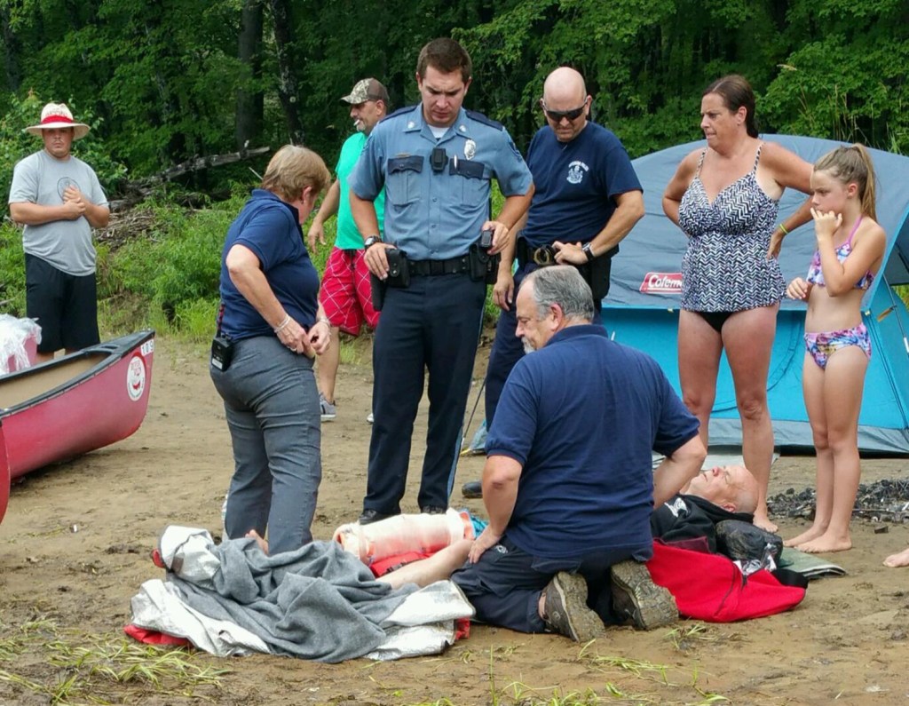 Fryeburg police and emergency crews treat  a man rescued from the Saco River after his canoe tipped over. Photo Courtesy of the Fryeburg Police Department