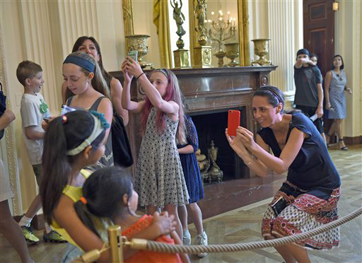 Visitors take photos while touring the White House  Wednesday. The Associated Press