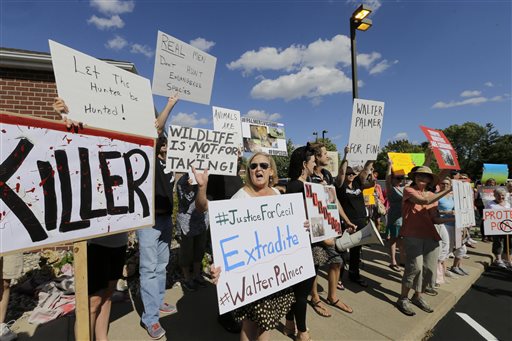 Protesters gather outside Dr. Walter James Palmer's dental office in Bloomington, Minn., Wednesday. The Associated Press