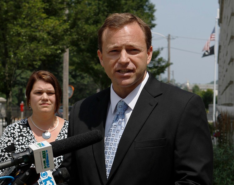 Maine House Speaker Mark Eves, joined by wife Laura, left, speaks outside of the federal courthouse in Portland about his lawsuit filed Thursday against Gov. Paul LePage.