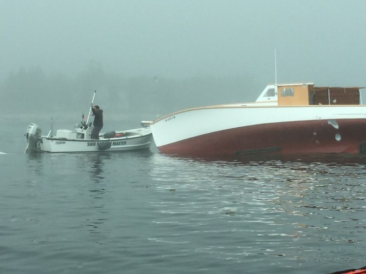 This pleasure boat ran aground Tuesday morning off Southwest Harbor, starting a series of events that led to the rescue of an elderly couple by a Coast Guard swimmer.