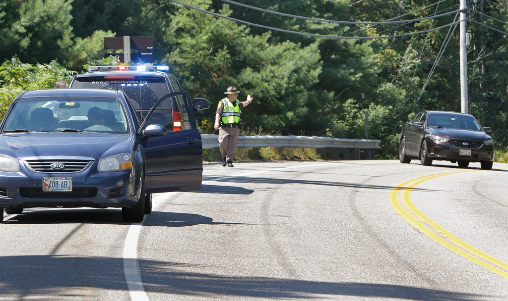 A Cumberland County sheriff's deputy directs traffic on Aug. 5 near the site where Isabella Slocum, 16, struck and killed Rita Douglas, 75, while Douglas walked her dog.
Press Herald file photo/Gregory Rec