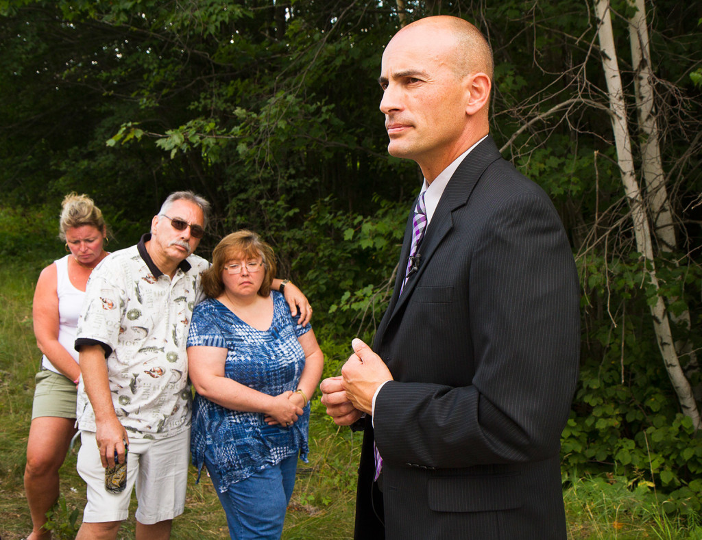 Ron Moreau and Karen Dalot, uncle and sister of Kimberly Moreau, listen to Maine State Police Detective Sgt. Mark Holmquist give an update on the search for Kimberly Moreau near Route 108 in Canton on Sunday.