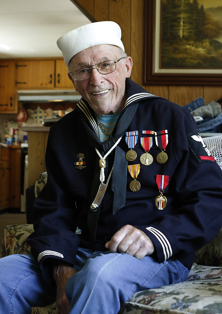 WWII veteran Conrad Lebourdais poses Sunday  in his Navy uniform at his home in Topsham. Lebourdais witnessed the surrender of the Japanese from the ship he was serving on. Joel Page/Staff Photographer