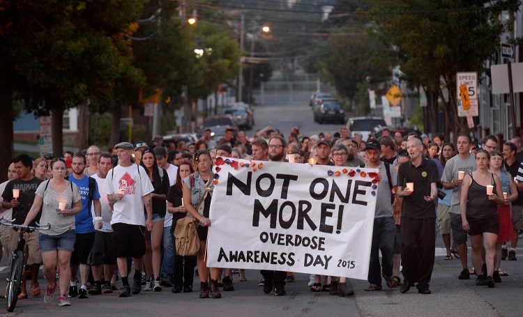 Participants march on Oxford Street in Portland on Monday evening during an event that was part of International Overdose Awareness Day.