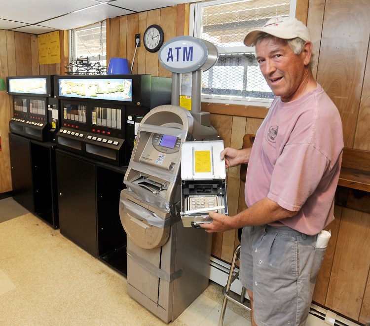 Don Cobb of American Legion Post 86 in Gray shows the money box and keypad that were destroyed by thieves who also broke into the office safe on Saturday.