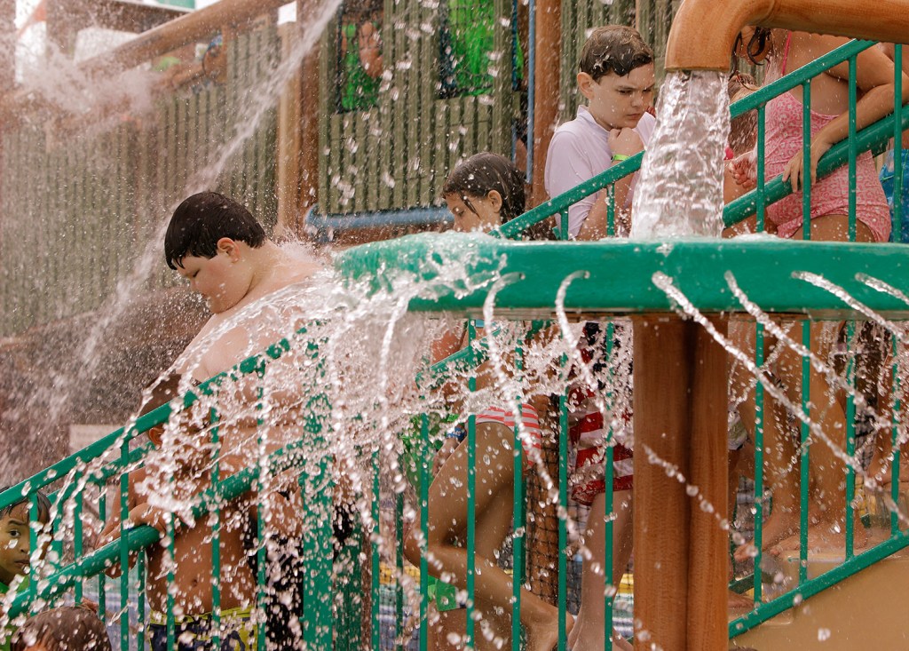 Dylan Dean, 11, walks down stairs among water sprays in the Pirates Paradise at Splashtown in Saco on Wednesday. The amusement park flew Dylan, who has Asperger's syndrome, and his family to Maine and gave them free passes to the park after they experienced an alleged bullying incident at a water park in their home state of Texas.