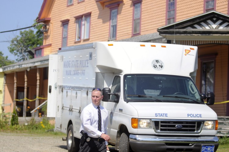 A Maine State Police detective on Sunday walks out of the driveway of a East Pittston boarding home where a stabbing occurred Saturday night.
