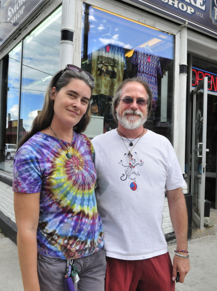 Angel and Jim O’Keeffe outside their Happy Trails store in downtown Waterville on Thursday. Colby College students will paint a mural on the Temple Street side of their building later this month, and build a temporary park on the corner Thursday, as part of freshman orientation.