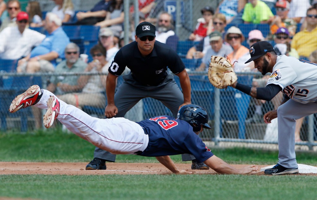 Sam Travis of the Sea Dogs dives back to first base on a pickoff attempt as Akron’s Ronny Rodriguez fields the throw Sunday at Hadlock Field. Akron won, 4-1.
Joel Page/Staff Photographer