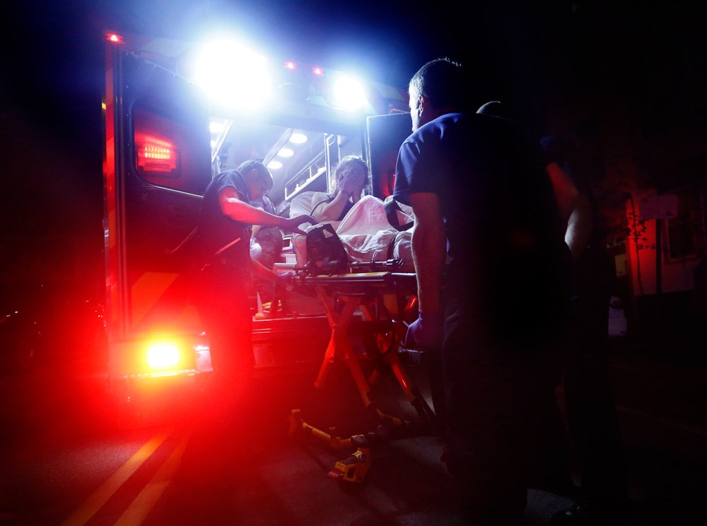 Portland paramedics load a woman into an ambulance after she overdosed on heroin in August. She survived, but 174 people in Maine died from overdoses in the first nine months of this year, according to new figures from the state Medical Examiner's Office.