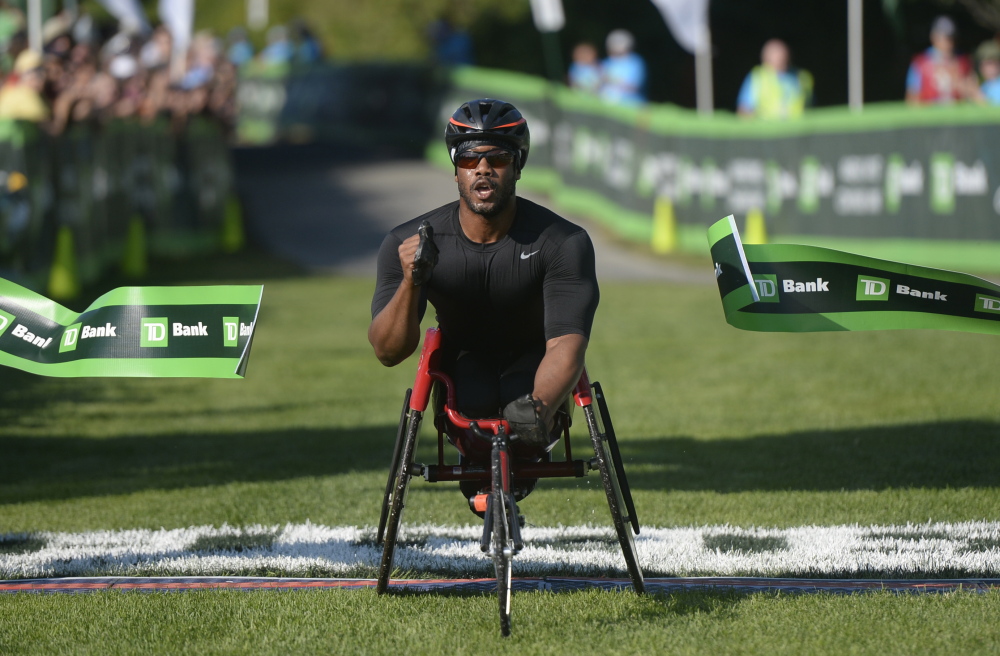James Senbeta of Champaign, Illinois, is the first in the wheelchair category to cross the finish line of Saturday’s TD Beach to Beacon 10K.