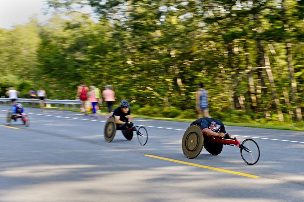 The wheelchair athletes race down the course at the Beach to Beacon 10K on Saturday in Cape Elizabeth.