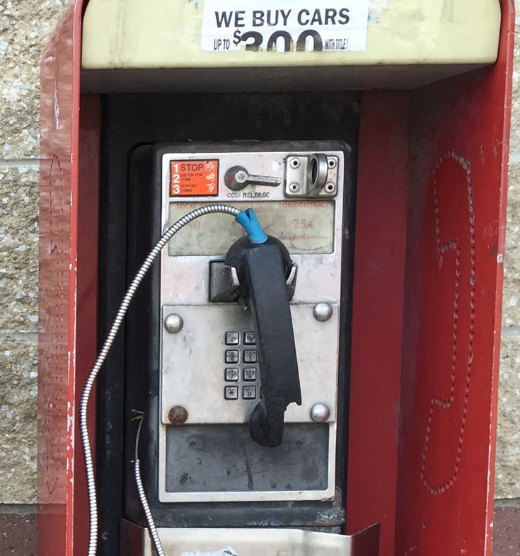 A pay phone remains at a gas station. The Associated Press