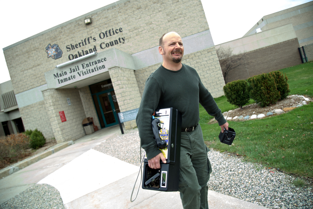 Greg Andrick collects a pay phone from the jail in Pontiac, Mich. “This used to be quite a booming business,” he said. 