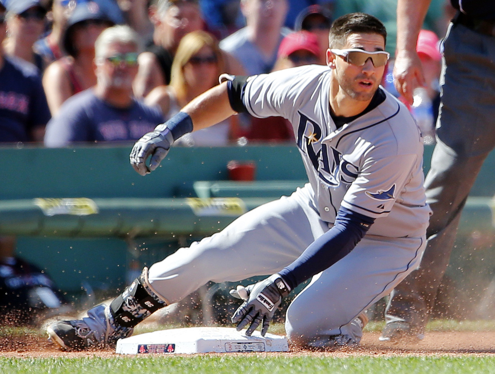 Rays center fielder Kevin Kiermaier slides into third base with a triple against the Boston Red Sox in the seventh inning at Fenway Park in Boston on Sunday. 