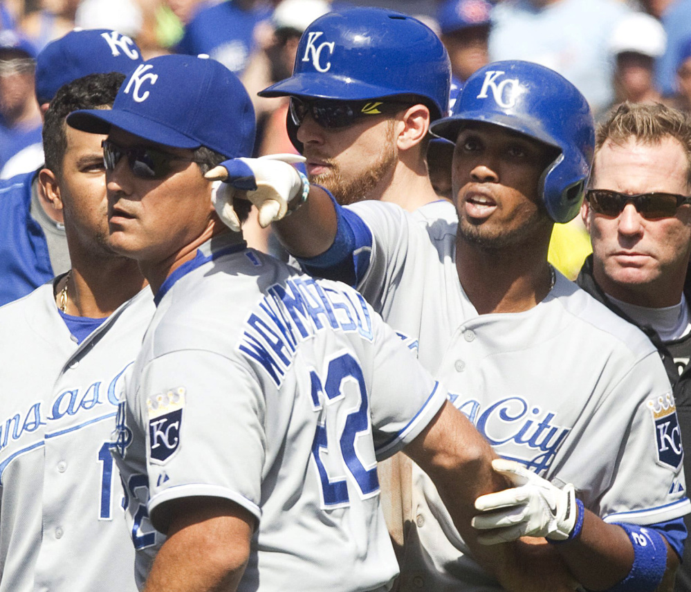 Kansas City’s Alcides Escobar, right, is held back during a scuffle that broke out in the eighth inning of the Blue Jays’ 5-2 win at Toronto on Sunday.