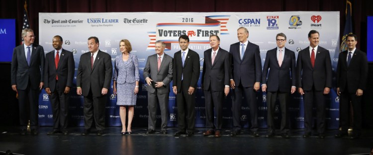 Republican presidential candidates gather on stage before Monday night’s forum in Manchester, N.H. From left are Jeb Bush, Ben Carson, Chris Christie, Carly Fiorina, Lindsey Graham, Bobby Jindal, John Kasich, George Pataki, Rick Perry, Rick Santorum and Scott Walker.
