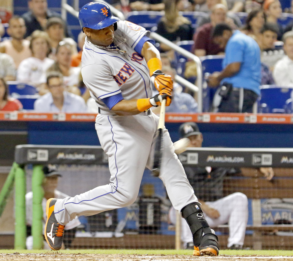 Yoenis Cespedes of the New York Mets hits a double to drive in two runs in the fifth inning during a 12-1 win by the Mets over the Marlins at Miami on Monday.