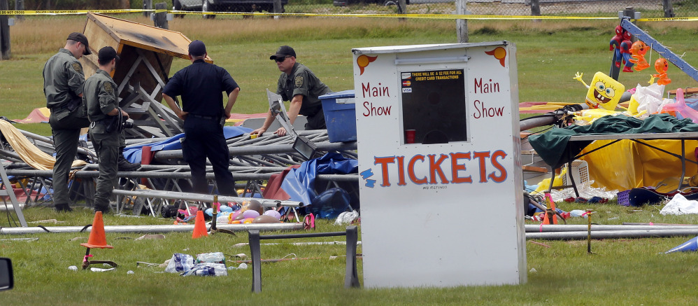 Investigators inspect the scene where a circus tent collapsed Monday in Lancaster, New Hampshire, killing two.