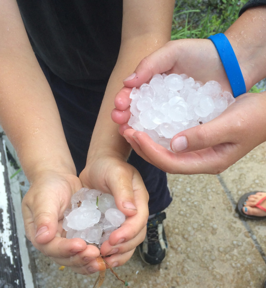 Kate and Dan Gallagher show some of the hail they collected from Tuesday's storm in Portland.
