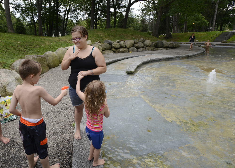 Megan Sargent of Portland plays Tuesday in the wading pool at Deering Oaks with her children Dougie Wright, 6, and Shyanne Wright, 3. Police say the park has become a “hotspot” for drug users, and city crews check parts of the park daily for discarded needles.