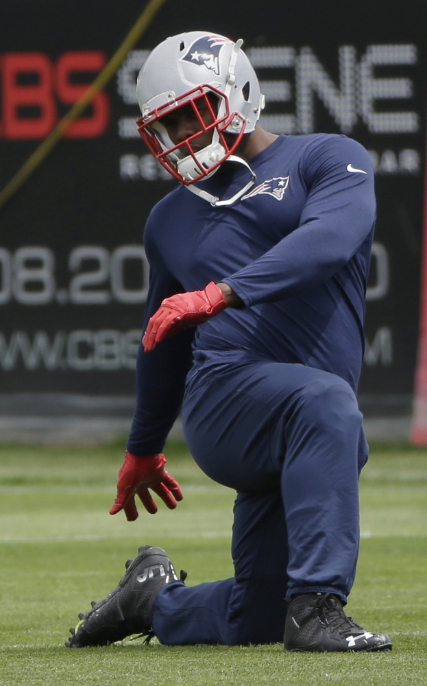Patriots defensive lineman Dominique Easley stretches during an NFL football minicamp in June.