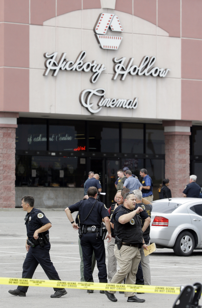 Police work outside a movie theater following a shooting Wednesday in Antioch, Tenn. An armed suspect who saturated audience members with pepper spray inside the theater died after exchanging gunshots with a SWAT team that stormed the theater, police said.