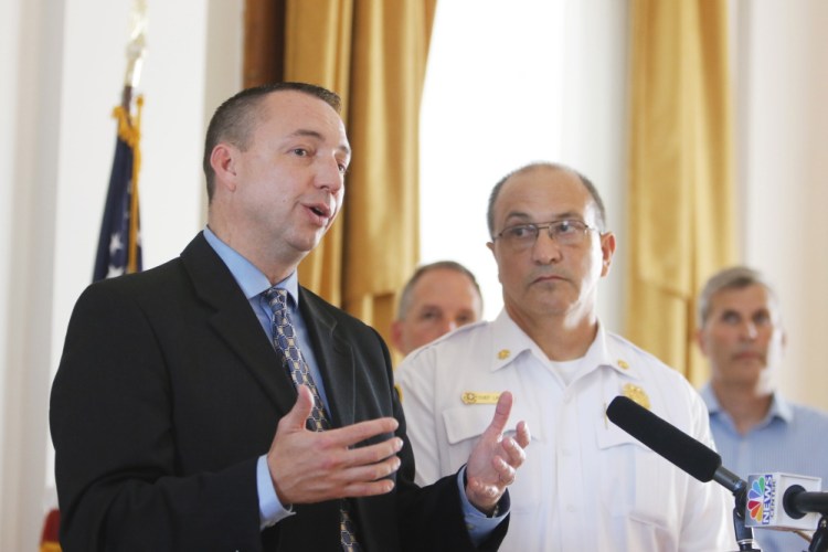 Portland Police Chief Michael Sauschuck, accompanied by Fire Chief Jerome LaMoria, speaks at a City Hall news conference Wednesday to raise awareness about the growing use of opiates and the recent spike in overdoses in the city. Sauschuck said combating the problem will take prevention, rehabilitation and law enforcement.