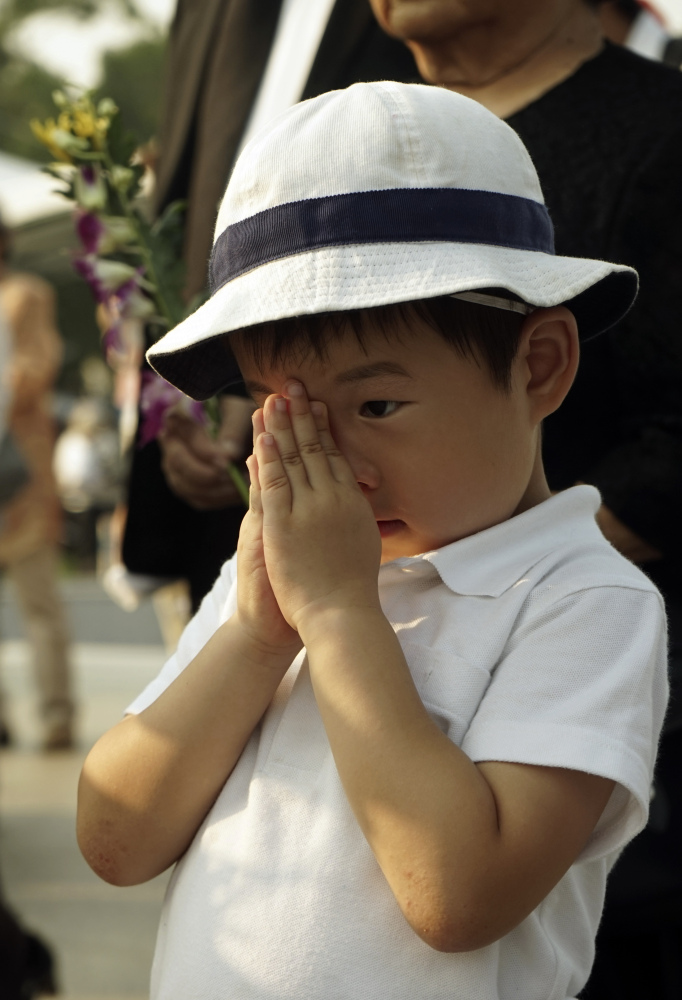 A boy in Memorial Park in Hiroshima prays Thursday for the victims of the atomic bombing of that city.
