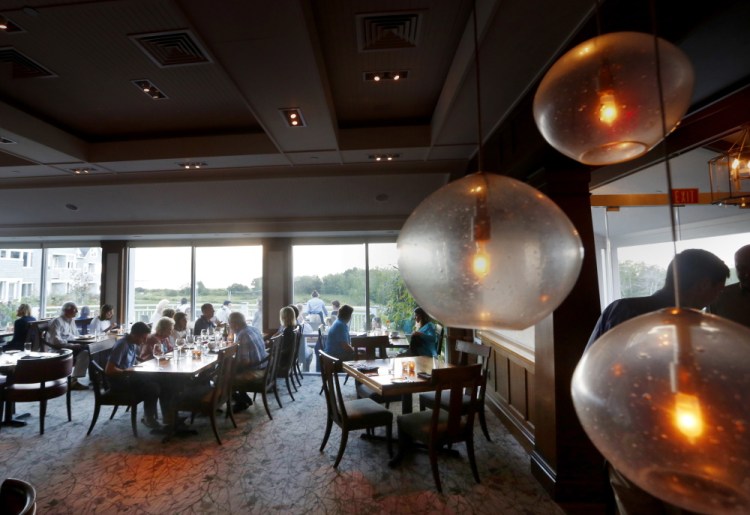 The dining room at Sea Glass overlooks Inn by the Sea’s grounds and the ocean beyond.