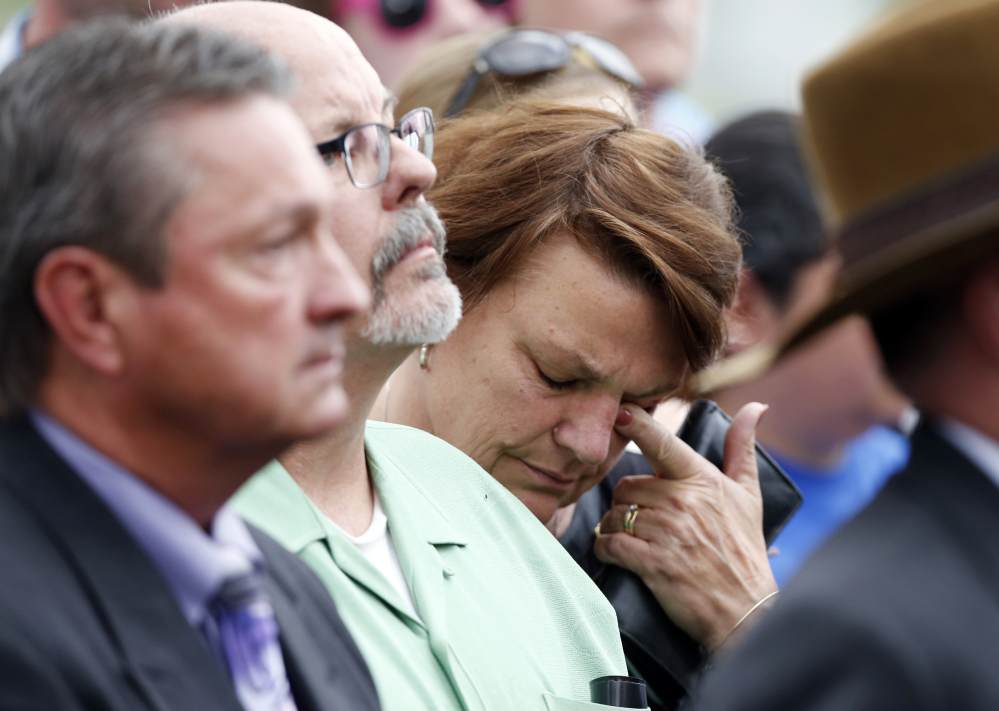 A woman who accompanied Tom Sullivan, who lost his son, Alex, in the theater shootings, wipes tears outside the Arapahoe County Courthouse after hearing the jury’s decision.