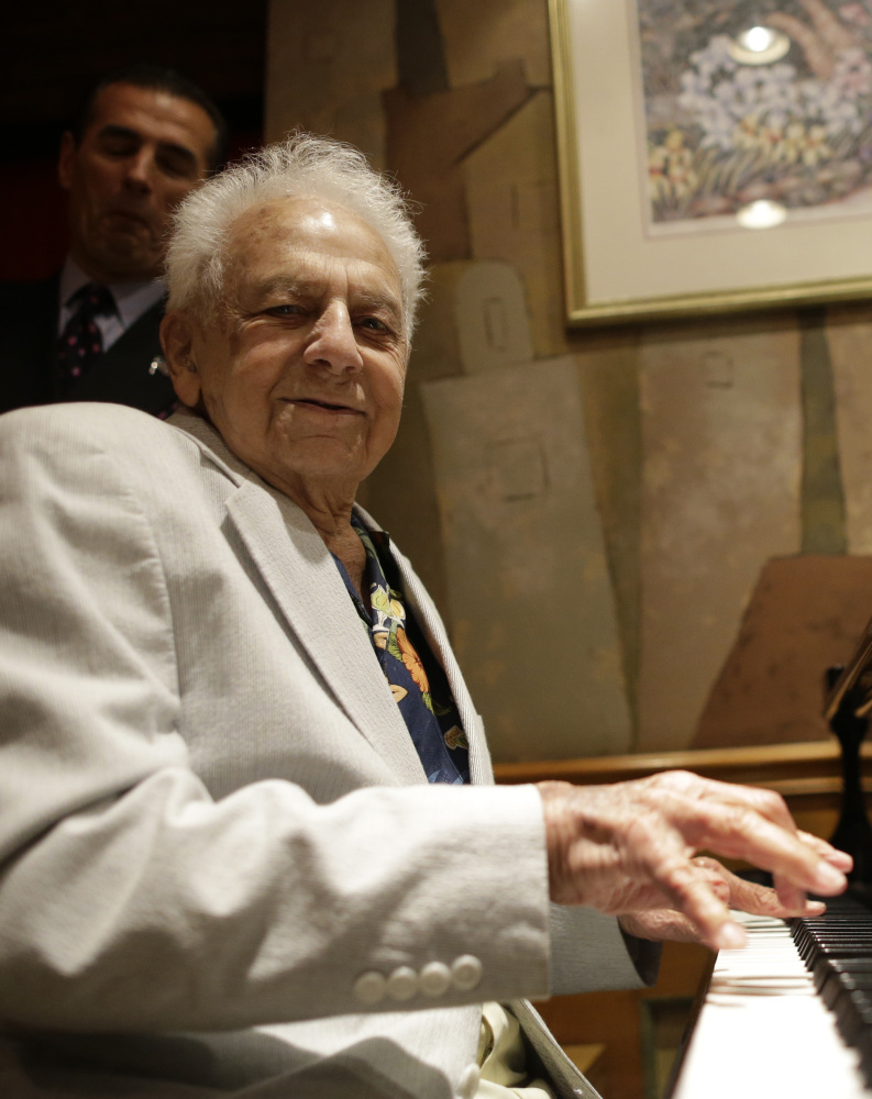 Irving Shields plays the piano Friday during a 100th birthday celebration for him at Nino’s Tuscany restaurant in New York.