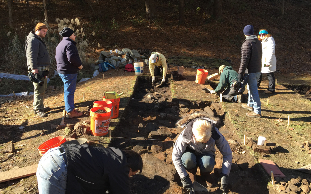 In this Nov. 19, 2014 photo made available by Bill Richardson, shows the descendants of the Hatfield and Mc Coy families clearing the homesite of Randall McCoy in Pike County, KY. The descendants are looking to uncover artifacts from the site which was set ablaze by the Hatfield clan during an attack on New Year's Day in 1888. (Bill Richardson via AP)