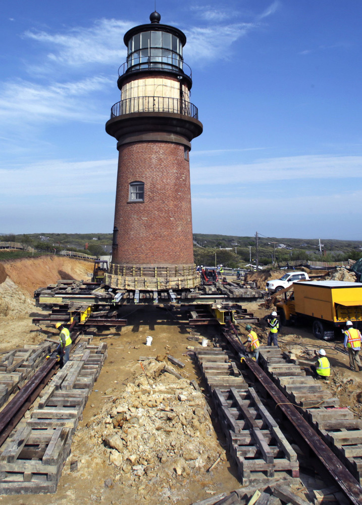 Workers move Gay Head Light along rails May 28 in Aquinnah, Mass., on Martha’s Vineyard. It’s light will shine again Tuesday.