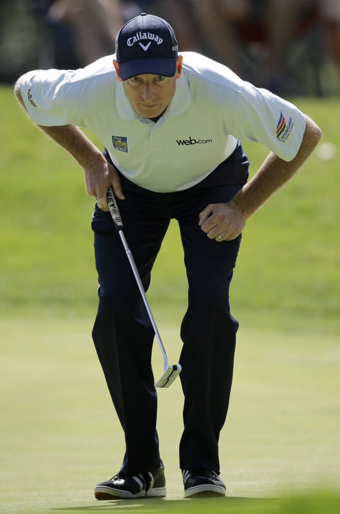 Jim Furyk lines up a putt on the 11th hole during the second round of the Bridgestone Invitational golf tournament Friday at Firestone Country Club in Akron, Ohio. Furyk shot a 4-under 66 for the second straight day and leads by four strokes at the midway point of the tournament.