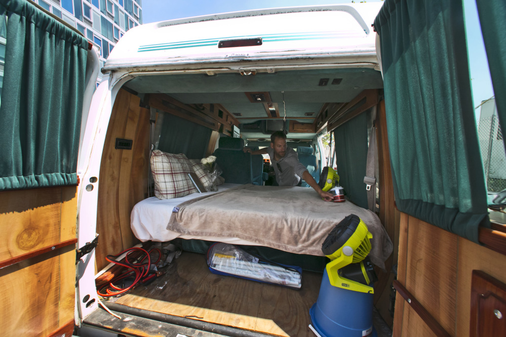 Jonathan Powley prepares his parked conversion van for visitors in the Queens borough of  New York.