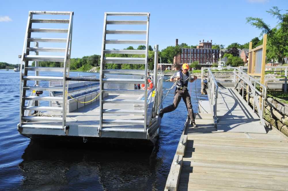 Andrew Marshall, a summer employee working on Swan Island, jumps onto the dock to tie up the new ferry Thursday as it approaches Richmond.