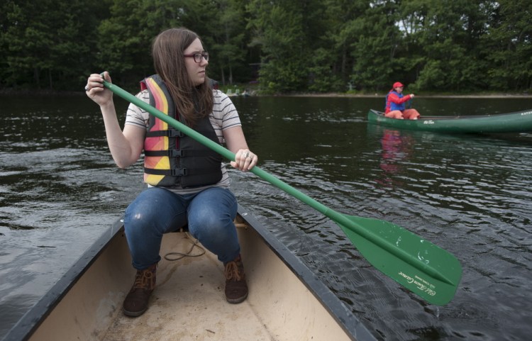 University of Maine wildlife ecology student Caroline MacKenzie paddles Fields Pond in Orrington on Thursday with her boss, Cyndi Kuhn. As part of her paid internship, she’ll be leading group tours there. MacKenzie says having to work while going to school means she can’t graduate as quickly as she’d like, which in turn means higher debt.
Kevin Bennett Photo