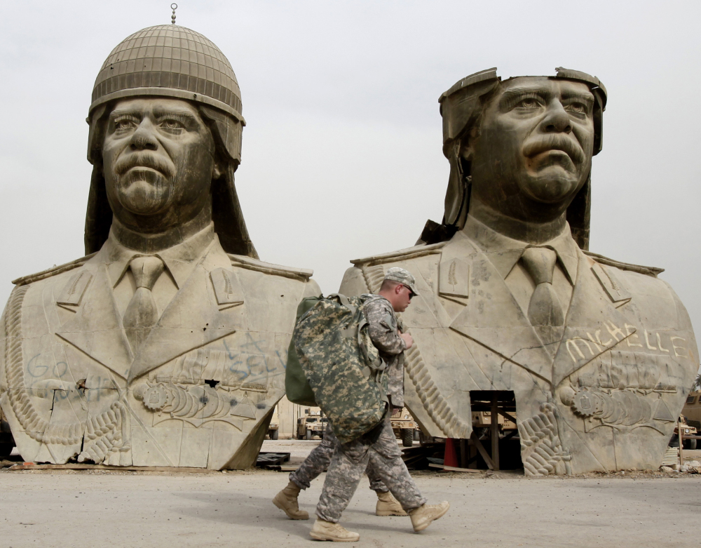 U.S. Army soldiers pass bronze busts of former Iraqi President Saddam Hussein in Baghdad in March 2009. Military and intelligence leaders from Saddam’s regime now dominate the Islamic State group’s top command, according to senior Iraqi officers.