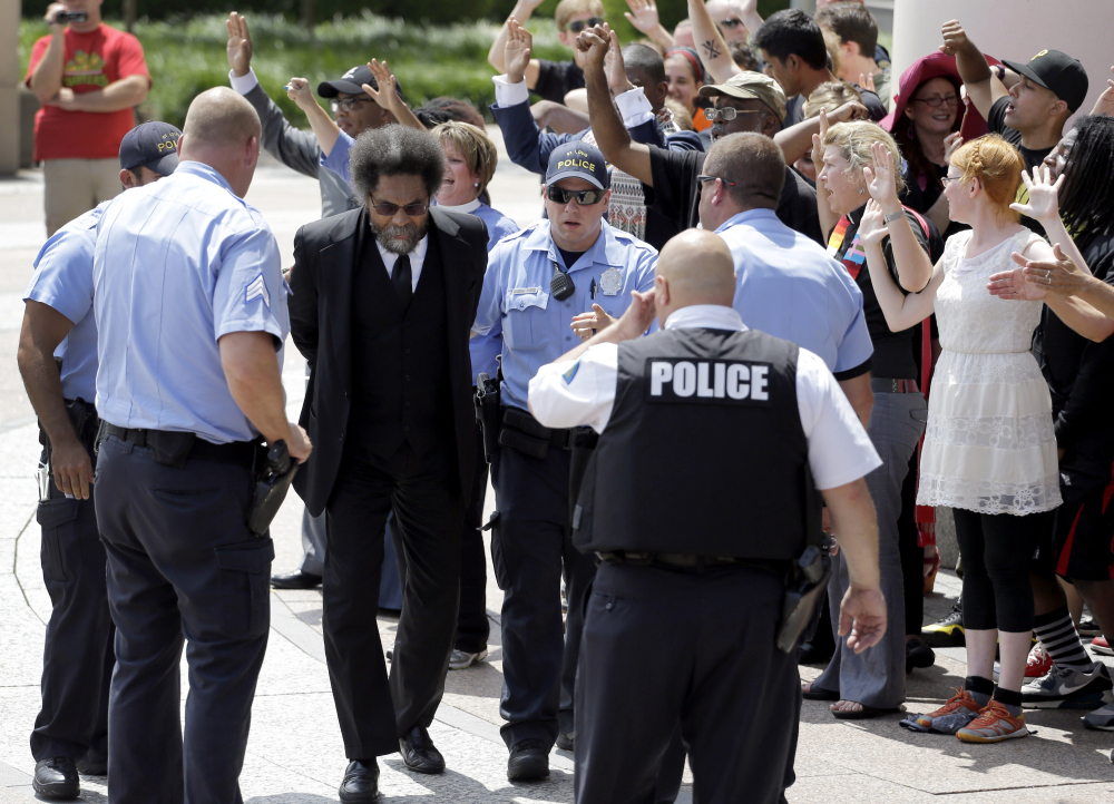 Civil rights activist Cornel West is arrested by St. Louis police during a protest outside the Thomas F. Eagleton Federal Courthouse in St. Louis on Monday. The arrests of West and a few dozen others were part of what was billed as a national day of civil disobedience.
